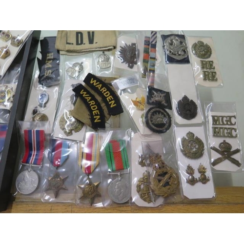 752 - A collection of military buttons, badges etc and 4 unnamed WWII medals