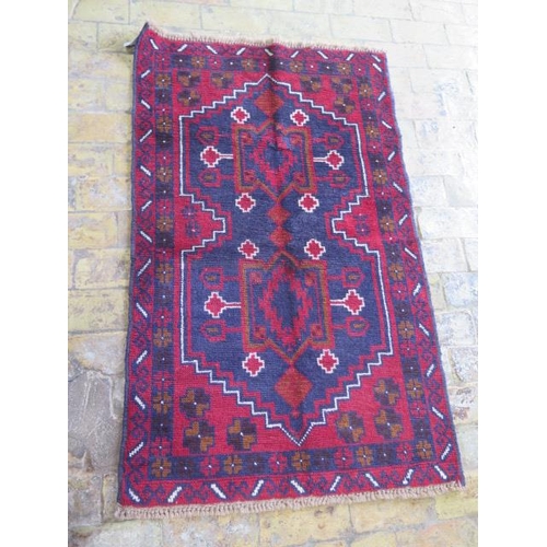 A hand knotted woollen new Baluchi rug, 138cm x 85cm