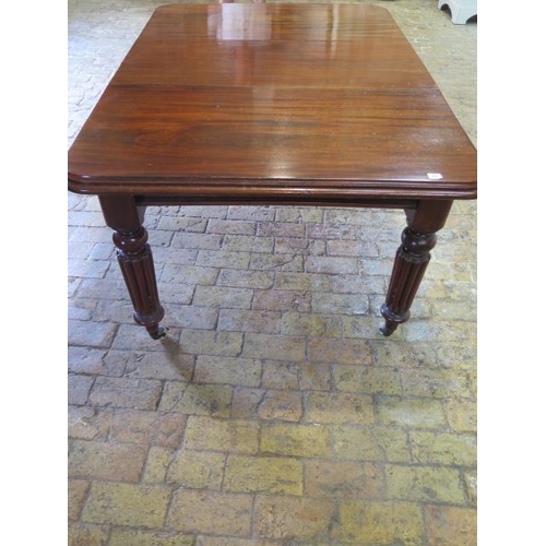 24 - A 19th century mahogany dining table with a single leaf on reeded legs, in good condition, with its ... 