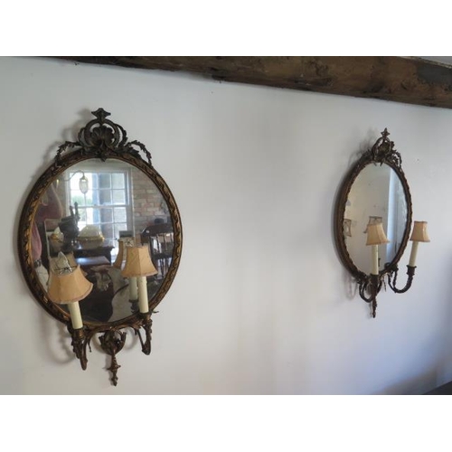 62 - A pair of gilt girondelle twin branch wall mirrors, 100cm x 56cm, some cracking and minor losses, sp... 