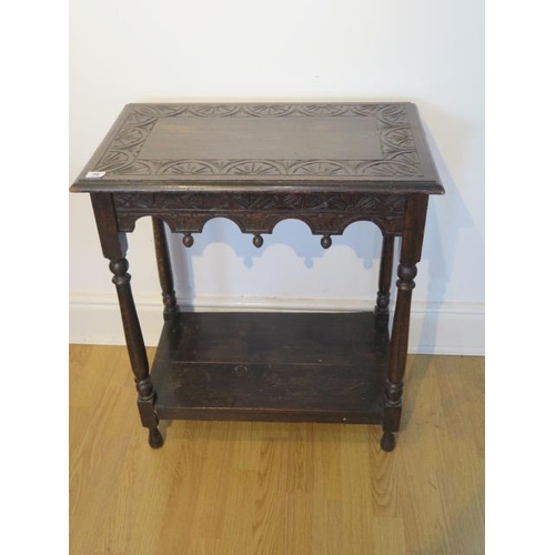 75 - A carved oak hall / side table with a shaped frieze and undertier, 73cm tall x 64cm x 39cm