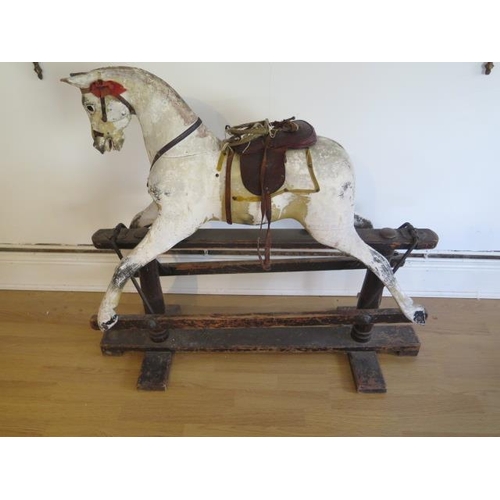 762 - An early 20th painted rocking horse in need of some restoration, 96cm tall, removed from a Country M... 