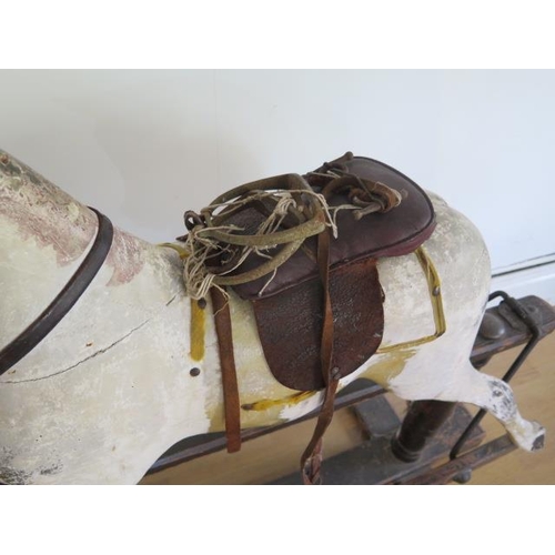 762 - An early 20th painted rocking horse in need of some restoration, 96cm tall, removed from a Country M... 