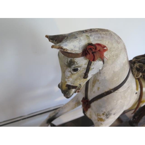 762 - An early 20th painted rocking horse in need of some restoration, 96cm tall, removed from a Country M... 