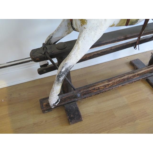 762 - An early 20th painted rocking horse in need of some restoration, 96cm tall, removed from a Country M... 