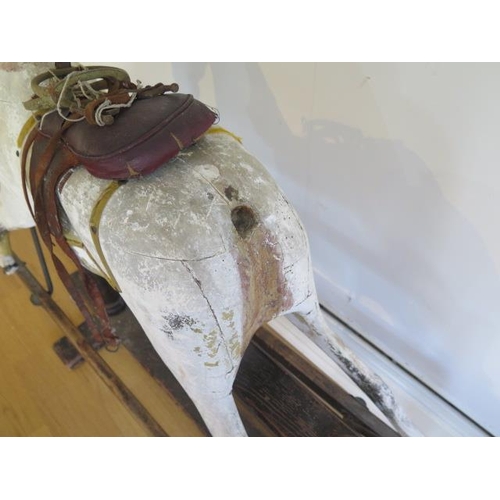 762 - An early 20th painted rocking horse in need of some restoration, 96cm tall, removed from a Country M... 