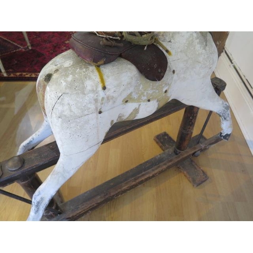 762 - An early 20th painted rocking horse in need of some restoration, 96cm tall, removed from a Country M... 