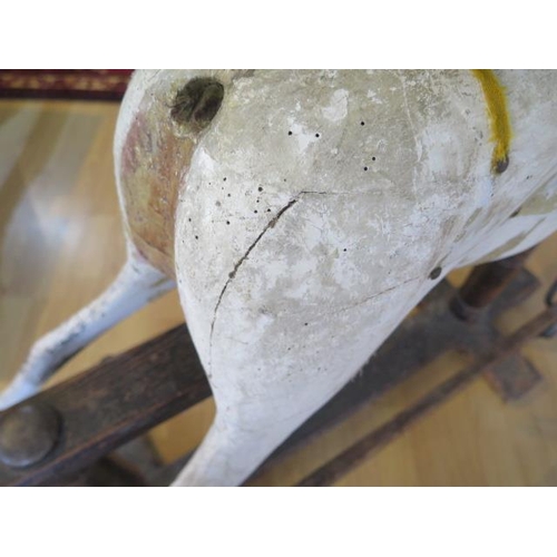 762 - An early 20th painted rocking horse in need of some restoration, 96cm tall, removed from a Country M... 