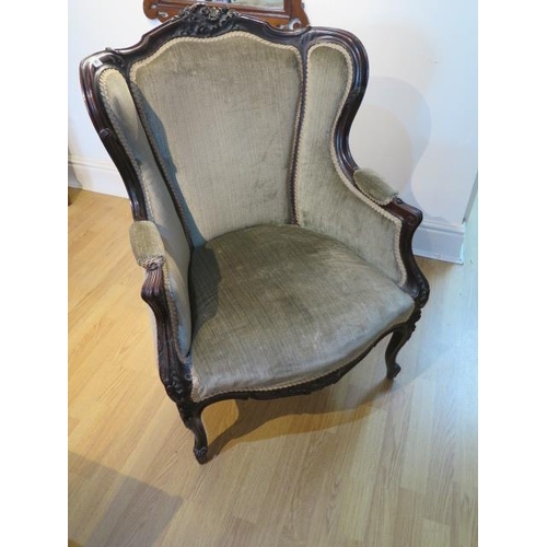 91 - A late Victorian carved mahogany upholstered wing back chair, 95cm tall x 70cm wide