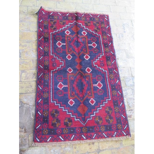 192 - A hand knotted woollen new Baluchi rug, 138cm x 85cm