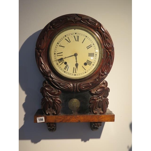 154 - An American carved 8 day striking wall clock, 53cm tall, running order