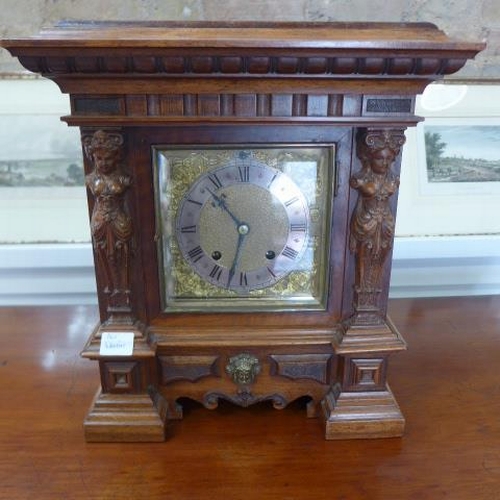 160 - A walnut 8 day striking mantle clock with figural supports - in running order - Height 39cm x 36cm x... 