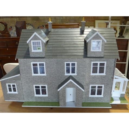 264 - A six room dolls house with conservatory, fully furnished, with lift out front - Height 71cm x Width... 