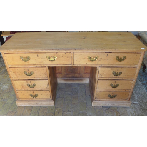 3 - A Victorian stripped pine 8 drawer kneehole desk with panelled back, 80cm tall x 163cm x 67cm