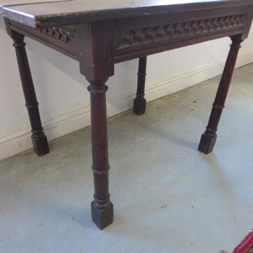 76 - An antique and later oak side table with a carved frieze - Height 71cm x 97cm x 62cm