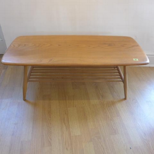 92 - An Ercol blond elm coffee table with spindle under tier - Height 37cm x 104cm x 46cm - good conditio... 