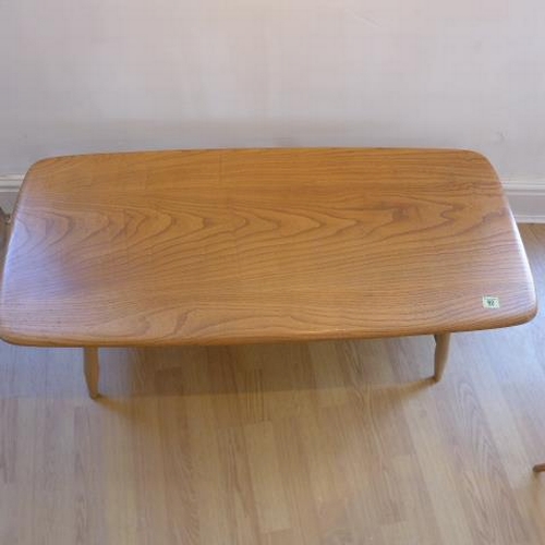 92 - An Ercol blond elm coffee table with spindle under tier - Height 37cm x 104cm x 46cm - good conditio... 