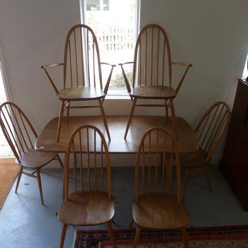 94 - An Ercol blond elm kitchen dining table with six stick back chairs including two carvers - Table hei... 