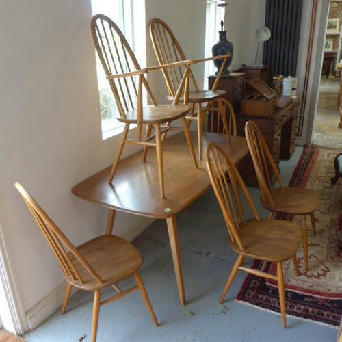 94 - An Ercol blond elm kitchen dining table with six stick back chairs including two carvers - Table hei... 