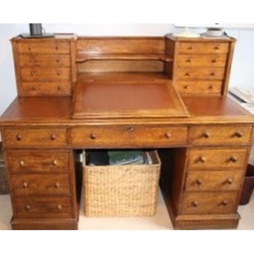 80 - A Victorian oak twin pedestal Dickens desk, the top having eight small drawers with a writing slope ... 