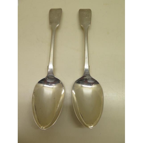 523 - A good pair of early Victorian sliver fiddle pattern table spoons with heraldic shield motif by Mary... 