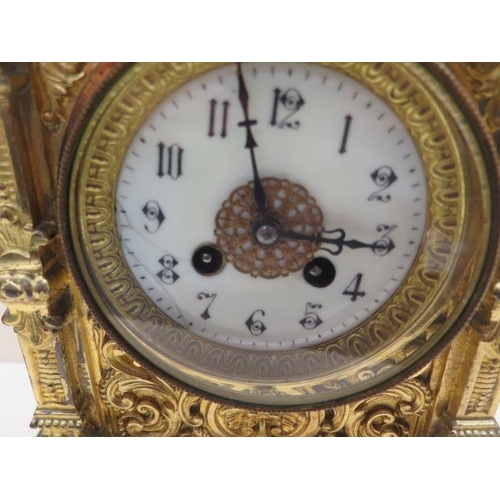 211 - A heavy brass ormolu striking mantle clock - Height 48cm - with a key and pendulum - appears overwou... 