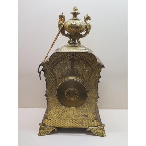 211 - A heavy brass ormolu striking mantle clock - Height 48cm - with a key and pendulum - appears overwou... 