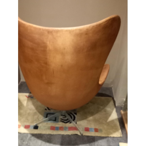 24 - A Danish Fritz Hansen tan leather swivel egg chair no 0966 *