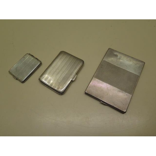 519 - Two silver cigarette cases and a match folder case - total weight 9.2 troy oz