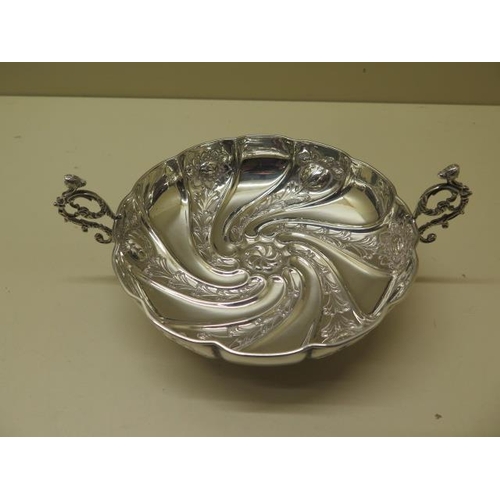 521 - An embossed silver twin handled bowl Birmingham 1891/92 SWS - width 17cm - approx weight 4.2 troy oz... 