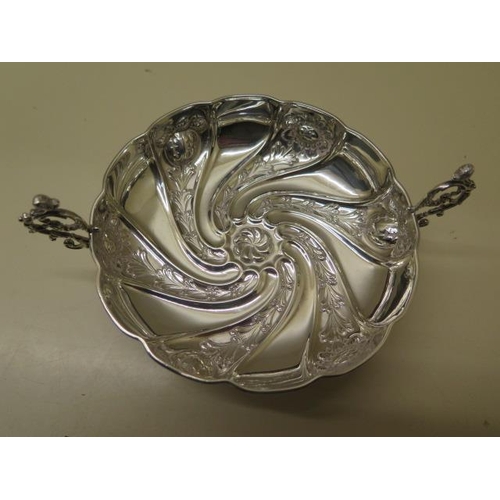 521 - An embossed silver twin handled bowl Birmingham 1891/92 SWS - width 17cm - approx weight 4.2 troy oz... 