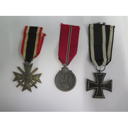 854 - Three German medals, an 1813/1914 Iron Cross a 1941/42 medal, a 1939 Cross of Honour all with ribbon... 