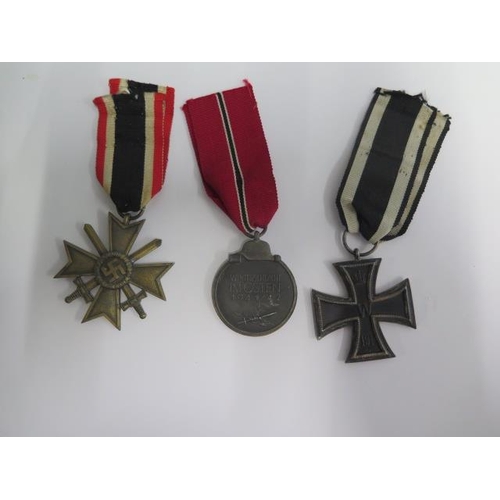 854 - Three German medals, an 1813/1914 Iron Cross a 1941/42 medal, a 1939 Cross of Honour all with ribbon... 