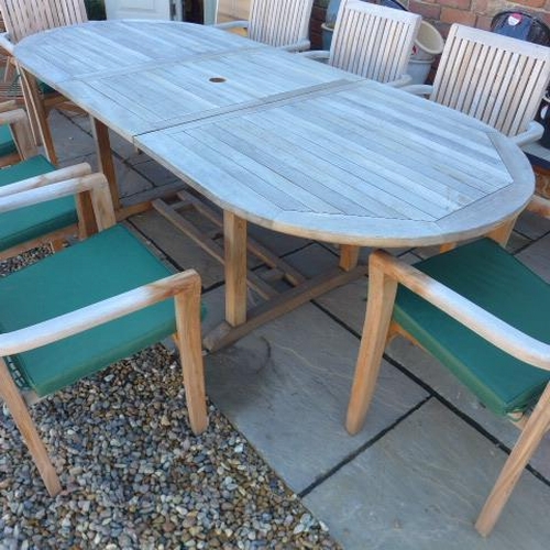 1 - A hardwood oval extending garden table and eight armchairs with seat pads - Table 75cm tall x 100cm ... 