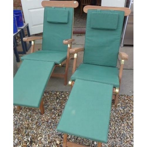 2 - A pair of hardwood and brass folding steamer chairs with green cushions