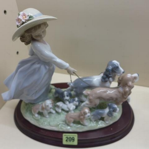 209 - A Lladro group Girl in bonnet walking dogs and puppies, Puppy Parade on a base 27cm tall, minor foli... 