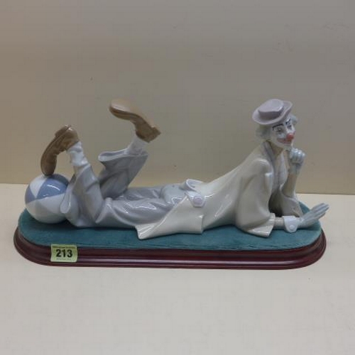 213 - A Lladro figure of a reclining clown on a base, no 4618 - Length 40cm - good condition, no box