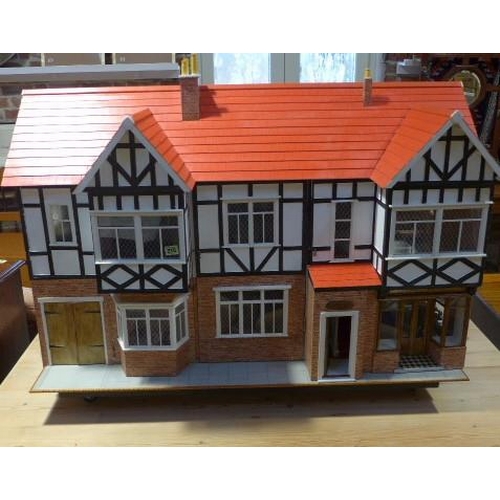 215 - A large dolls house with six rooms, a garage and  a boutique with furnishings on a caster base - Hei... 