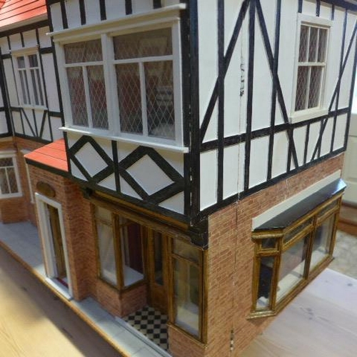 215 - A large dolls house with six rooms, a garage and  a boutique with furnishings on a caster base - Hei... 