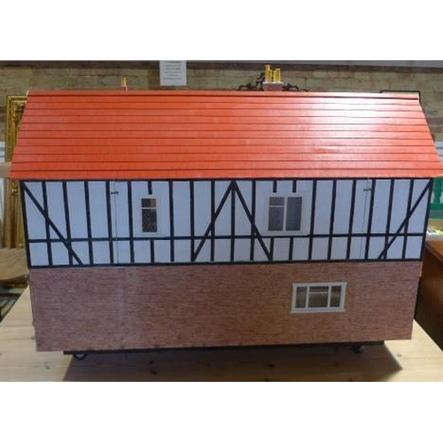 215 - A large dolls house with six rooms, a garage and  a boutique with furnishings on a caster base - Hei... 