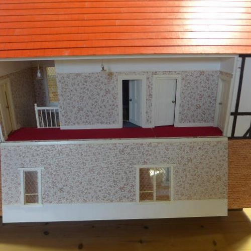 215 - A large dolls house with six rooms, a garage and  a boutique with furnishings on a caster base - Hei... 