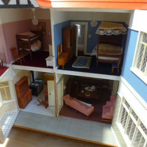 215 - A large dolls house with six rooms, a garage and  a boutique with furnishings on a caster base - Hei... 