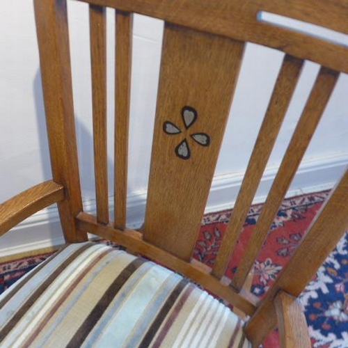 28 - A recently reupholstered oak rocking chair - Height 87cm