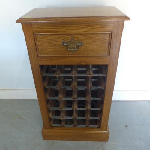 57 - An oak 24 bottle wine rack with a drawer - 94cm x 51cm x 28cm