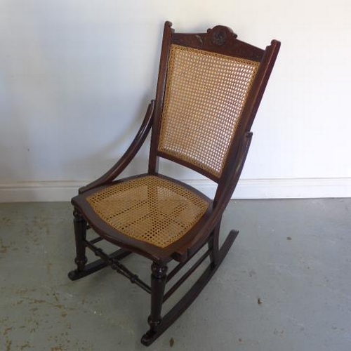 60 - A circa 1900's rocking chair with cane seat and back stamped J.C. - Height 95cm - in polished condit... 
