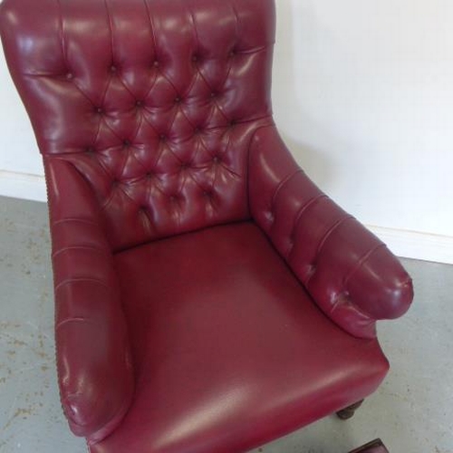 65 - A late Victorian armchair reupholstered in maroon button faux leather with a footstool - Height of c... 