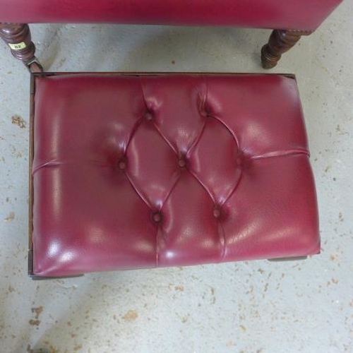 65 - A late Victorian armchair reupholstered in maroon button faux leather with a footstool - Height of c... 