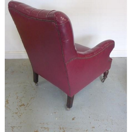 65 - A late Victorian armchair reupholstered in maroon button faux leather with a footstool - Height of c... 