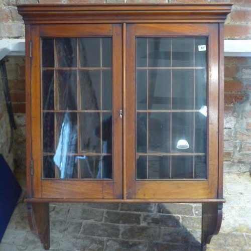 68 - A Victorian mahogany wall mounted two door glazed stationary cabinet with 24 pigeon holes enclosed b... 