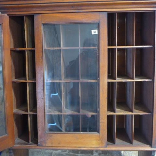 68 - A Victorian mahogany wall mounted two door glazed stationary cabinet with 24 pigeon holes enclosed b... 